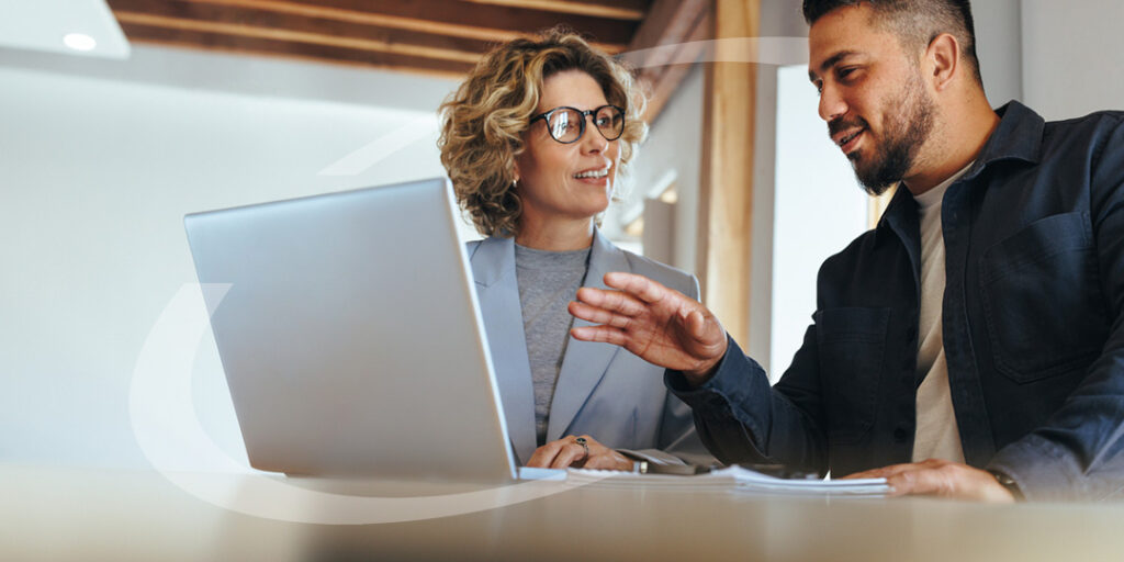 A broker meeting with a client as they animatedly discuss future plans
