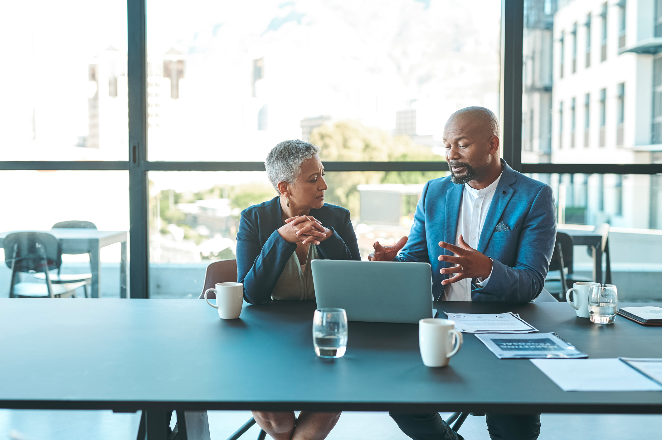 Businessman and client discussing a deal at a desk