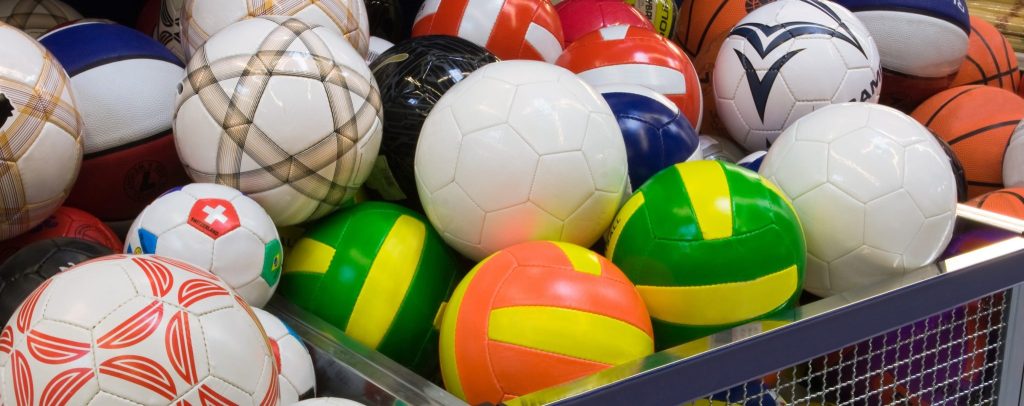 Basket full of soccer balls, all with unique colors